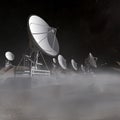 Space antenas on the desert in the foggy night