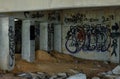 A space beneath a bridge, concrete pillars that support the structure above with walls covered in graffiti Royalty Free Stock Photo