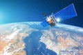 Space communications satellite in low orbit around the Earth. Elements of this image furnished by NASA. Royalty Free Stock Photo