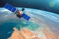 Space communications satellite in low orbit around the Earth. Elements of this image furnished by NASA. Royalty Free Stock Photo