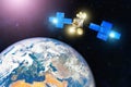 Space communications satellite in orbit around the Earth. Elements of this image furnished by NASA Royalty Free Stock Photo