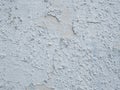 Space for filling. Pastel blue painted grunge wall. Uneven old wall surface closeup with flaking paint and rough layer underneath