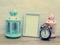 Space photo frame with candle light and vintage alarm clock Royalty Free Stock Photo