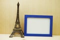 Space photo frame mock up with Eiffel tower souvenir on wooden background Royalty Free Stock Photo