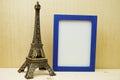 Space photo frame mock up with Eiffel tower souvenir on wooden background Royalty Free Stock Photo