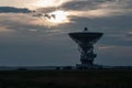 Space radar antenna. Satellite dish at sunset with cloudy sky