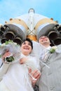 Space rocket over fiance and bride