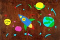 Space rocket and planets, solar system, Astronautics and stars on wooden background-application made by child