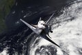 Space ship shuttle flying near earth from the hurricane and massive clouds in atmosphere, image made of NASA photos f Royalty Free Stock Photo