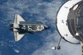 Space shuttle flies under the space station. Elements of this image were furnished by NASA Royalty Free Stock Photo