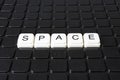 Space title text word crossword. Alphabet letter blocks game texture background. White alphabetical letters on black