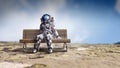 Rocketman on bench. Mixed media Royalty Free Stock Photo