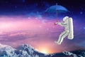 Spaceman on the umbrella traveling in outer space