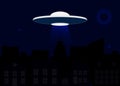 Spaceship of alien on dark night sky background with silhouette of city, moon, stars. UFO concept Royalty Free Stock Photo