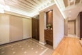 Spacious anteroom interior in warm tones and modern ceiling lights