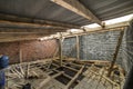 Spacious attic room under construction and renovation. Energy saving walls of large hollow foam insulation blocks and temporary