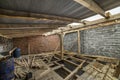 Spacious attic room under construction and renovation. Energy saving walls of large hollow foam insulation blocks and temporary