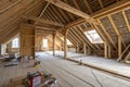 Spacious attic under construction with exposed wooden beams Royalty Free Stock Photo