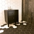 Spacious bathroom with tiled floor and black drawer unit Royalty Free Stock Photo