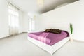 Spacious bed in bright bedroom Royalty Free Stock Photo