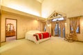 Spacious bedroom with beamed wooden ceiling Royalty Free Stock Photo