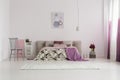 Spacious bedroom with pink blanket Royalty Free Stock Photo