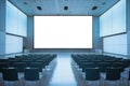 Spacious blue-themed conference room with a blank screen, rows of seating, and overhead lighting Royalty Free Stock Photo