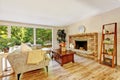 Spacious bright living room with glass wall and brick fireplace