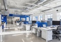 Modern Open Concept Office Interior With Blue Accents And Natural Light On Desks And Computers Royalty Free Stock Photo