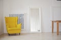 Spacious bright room, with a mirror and a bright accent in the form of an armchair. Furniture, vibrant designs in soothing colors Royalty Free Stock Photo