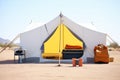 spacious canvas tent with a bed inside, desert backdrop Royalty Free Stock Photo