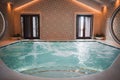 Spacious Circular Indoor Swimming Pool with Relaxing Atmosphere in Tiled Room