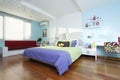 Spacious, clean and colorful child`s bedroom with sunlight coming through the windows