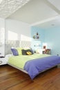 Spacious, clean and colorful child`s bedroom with sunlight coming through the windows
