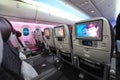 Spacious and comfortable economy class cabin of Qatar Airways Boeing 787-8 Dreamliner at Singapore Airshow Royalty Free Stock Photo