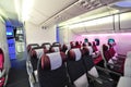 Spacious and comfortable economy class cabin of Qatar Airways Boeing 787-8 Dreamliner at Singapore Airshow Royalty Free Stock Photo