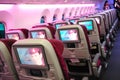 Spacious and comfortable economy class cabin of Qatar Airways Boeing 787-8 Dreamliner at Singapore Airshow Royalty Free Stock Photo