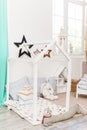 Spacious, decorated kid`s bedroom standing next to a modern wooden bed