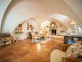 Spacious dining room with a white vaulted ceiling and a long wooden table with lots of chairs