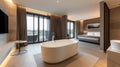 Spacious and elegant hotel room featuring a freestanding bathtub with panoramic city views through floor-to-ceiling Royalty Free Stock Photo