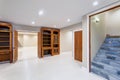 Spacious empty basement area with custom built bookcases. Royalty Free Stock Photo