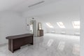 Spacious empty hollow attic with a tiled floor and a large mirror