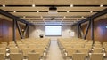 Spacious empty modern conference room ready for presentation, training, and corporate events with screen and chairs Royalty Free Stock Photo