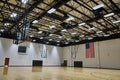 Spacious Indoor Basketball Court with American Flag and Hoops Royalty Free Stock Photo