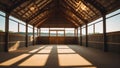 Interior shot of a rustic wooden barn with sunlight casting long shadows Royalty Free Stock Photo