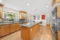 Spacious kitchen with granite counters and wooden cabinets in Encino, CA