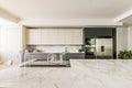 Spacious kitchen with plain white wood cabinets paired with shiny gray stainless steel appliances and large island with white Royalty Free Stock Photo