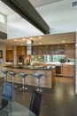 Spacious Kitchen With Stools At Island In House