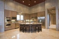 Spacious Kitchen With Stools At Island In House