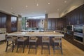 Spacious Kitchen With Stools At Island In House Royalty Free Stock Photo